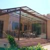Cerramiento de cristal, techo con cristal laminado y laterales con cortinas de cristal
