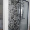 Baño cambio de bañera por plato de ducha resina negro, alicatado frente pared mismo mosaico que el suelo porcelanicoi